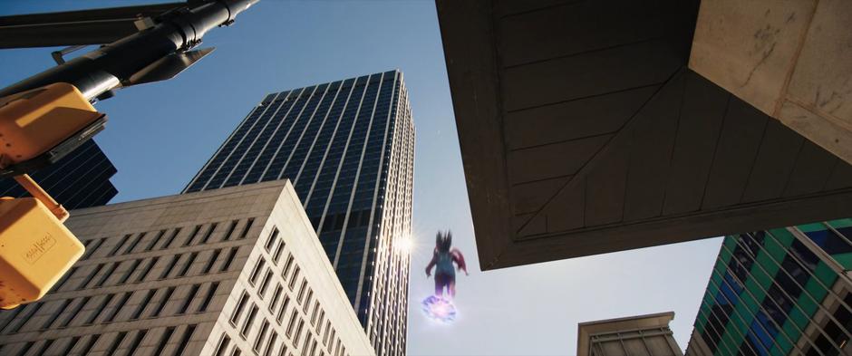 Kamala hops onto another hard light platform after leaping off a building overhang.