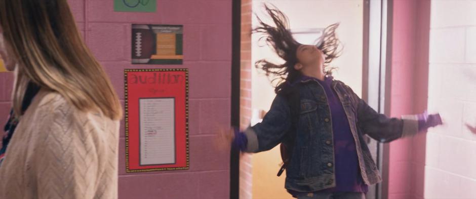 Kamala throws her head back as she triumphantly enters the school.