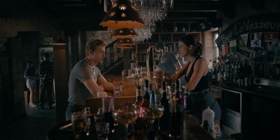 Miguel and Ava talk at the bar about the Samaritans.