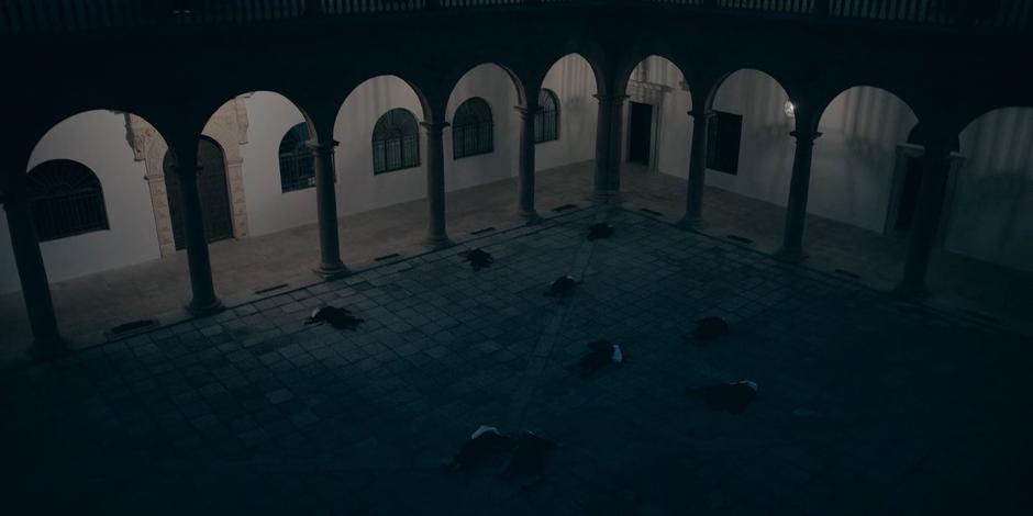 The nuns in the convent lie dead spread throughout the courtyard.