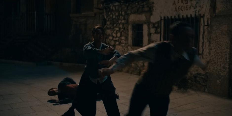 Bea pushes one of the cultists after fighting another to the ground.