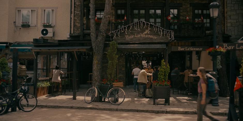 Establishing shot of the bar entrance during the day.