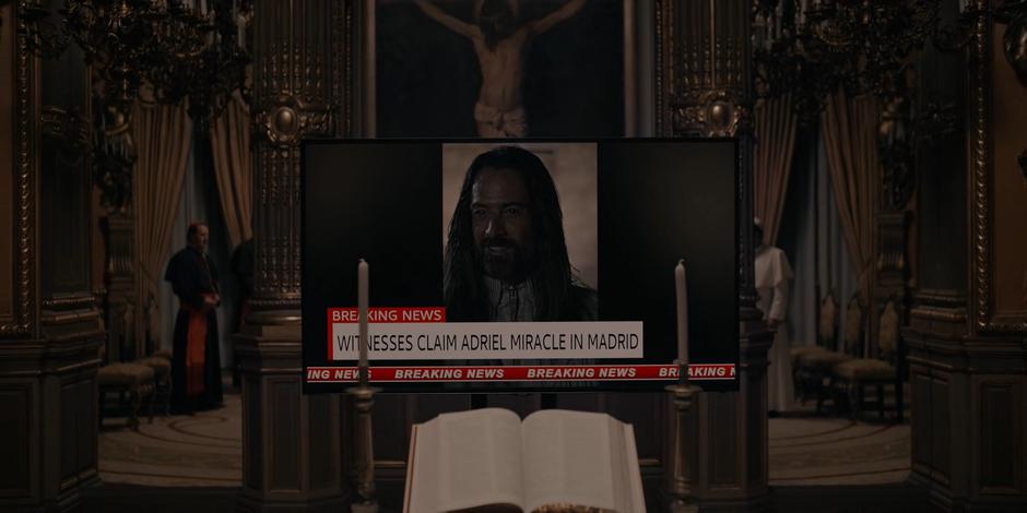 A news report of Adriel's miracle appears on a TV.