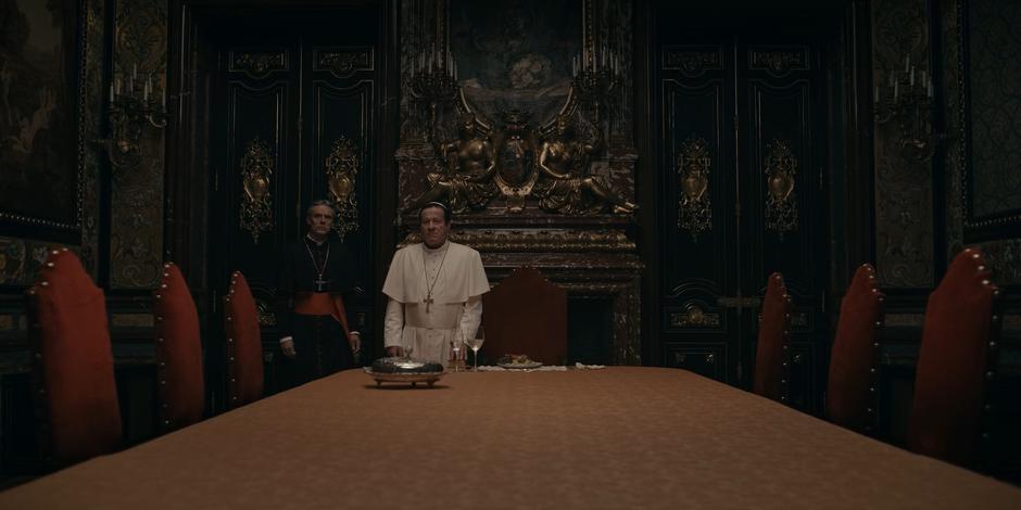 Cardinal Foster and Pope Duretti enter the meeting room to find Adriel waiting.