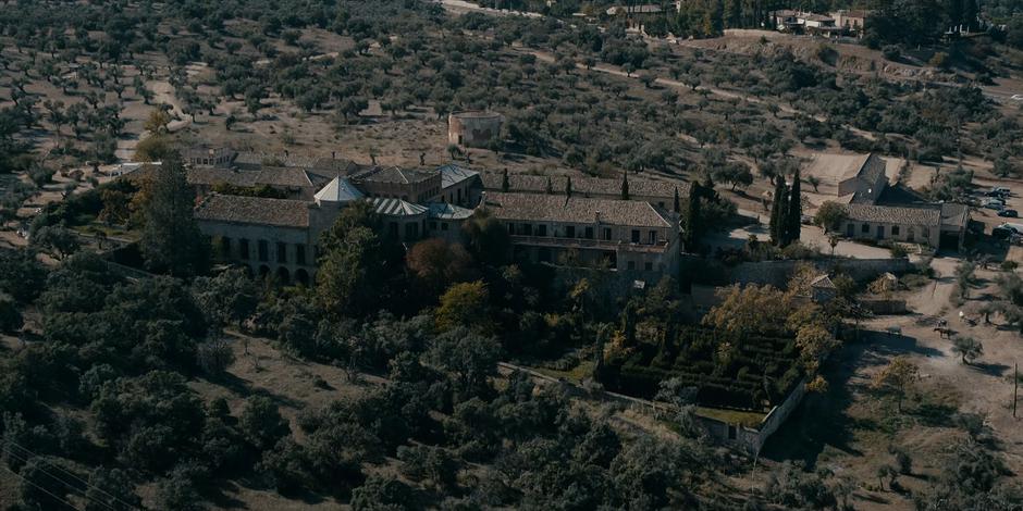 Aerial establishing shot of Jillian's villa during the daytime.