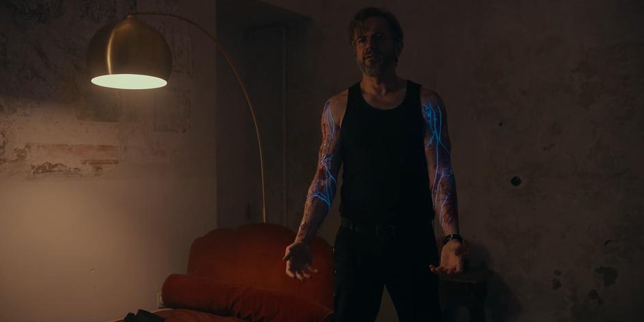 Vincent holds out his arms as the glowing Divinium from his tattoos flows down his arms.