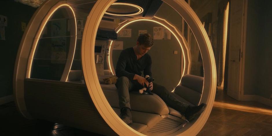 Michael sits in his old pod thinking as Jillian walks into the room.