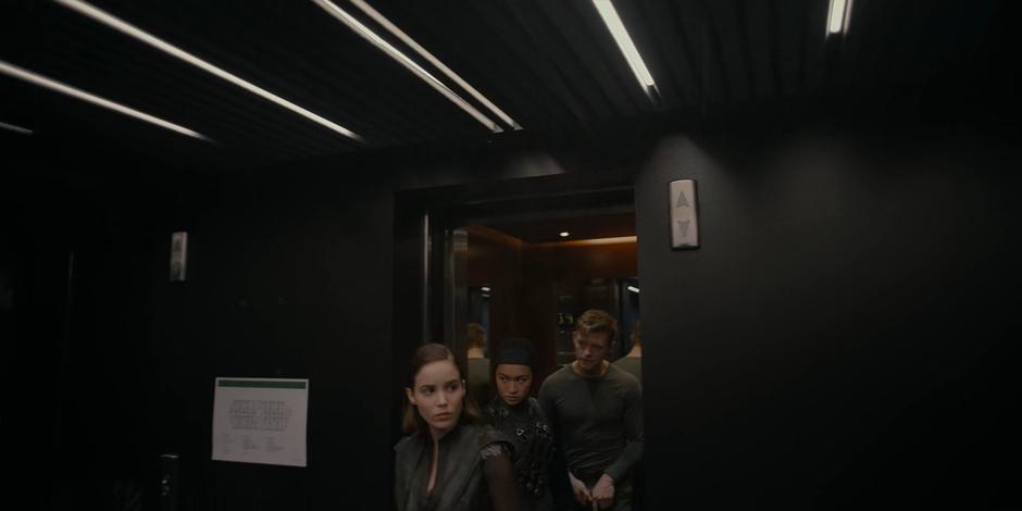 Ava, Bea, and Michael exit the elevator on the 13th floor.