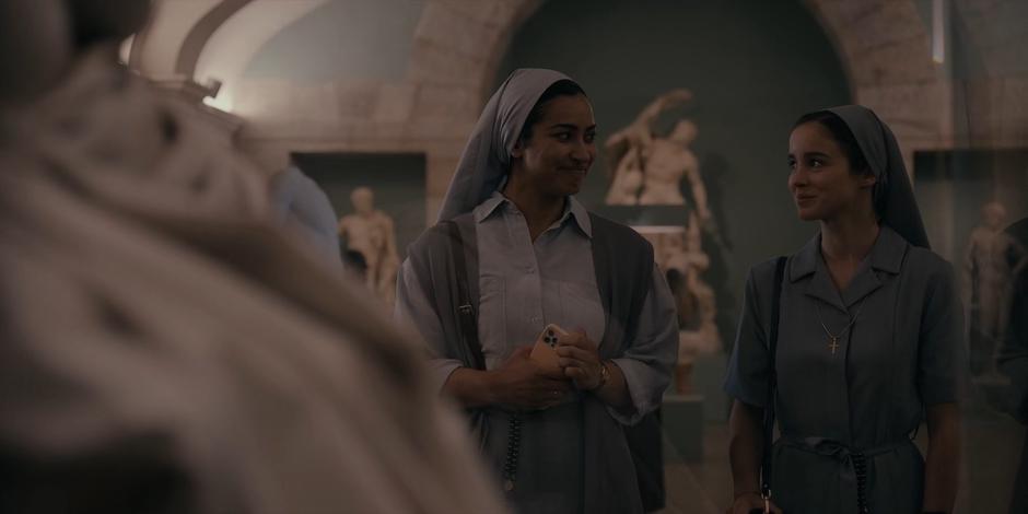 Yasmine and Ava smile at one another after finding the Crown of Thorns.