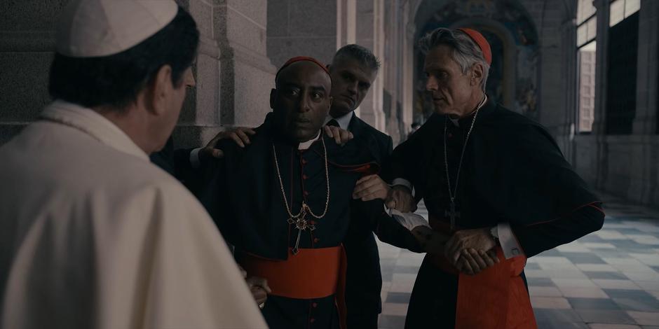 The guards and Cardinal Foster grab Cardinal Rossi after Duretti calls him out for being a mole for Adriel.