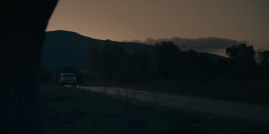 Ava, Bea, and Miguel exit the car and head closer to investigate.