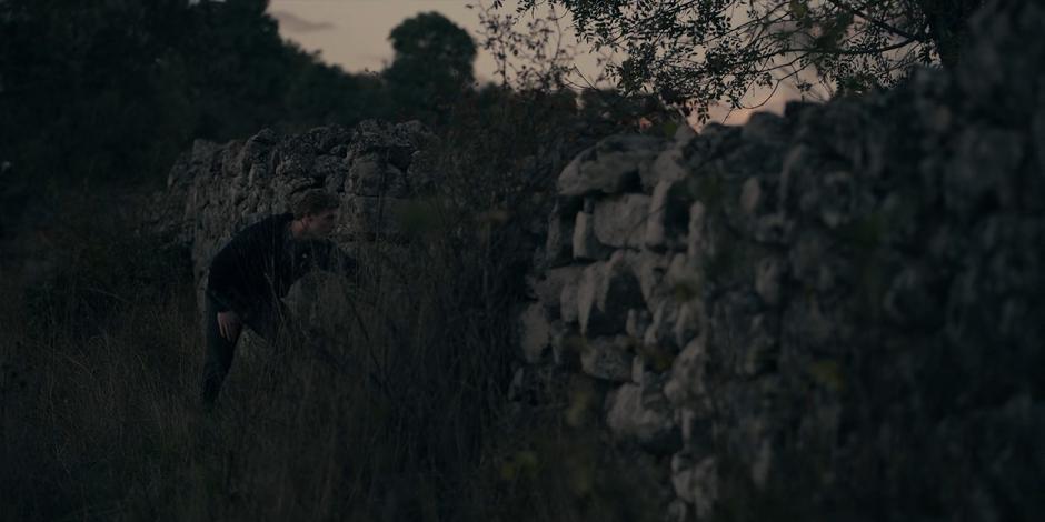 Miguel runs farther down the wall to get a better look at the field.