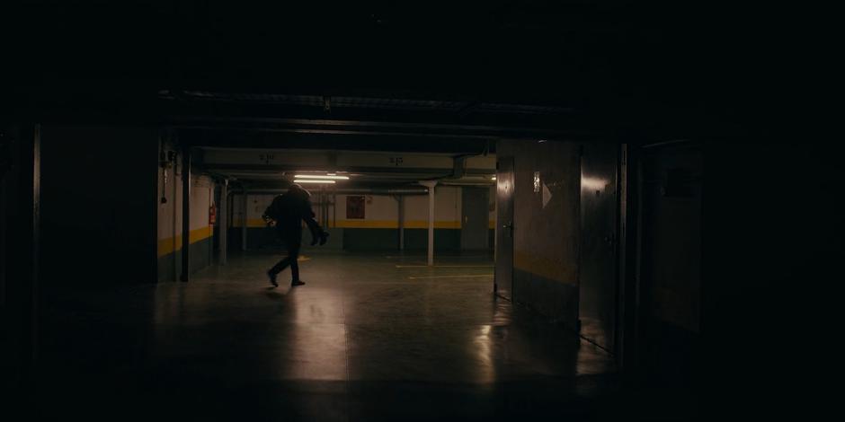 Vincent carries an unconscious Ava over his shoulder through the garage.