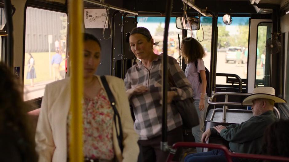 Sarah gets onto the bus and pays her fair.