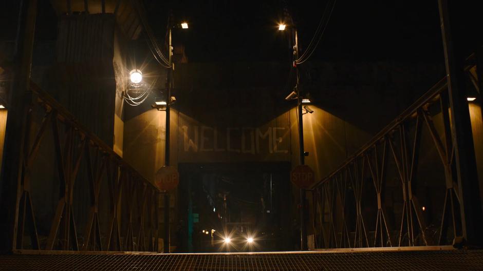 The front gate opens at night to let out a FEDRA vehicle.