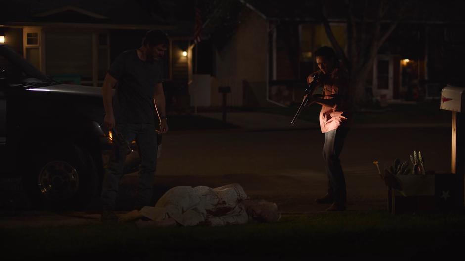 Joel and Tommy stand over the body of Nana Adler after she chased Sarah.