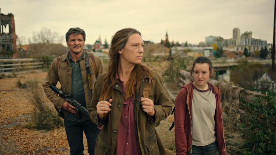 Joel, Tess, and Ellie look around while waiting to see if the cry resumes.