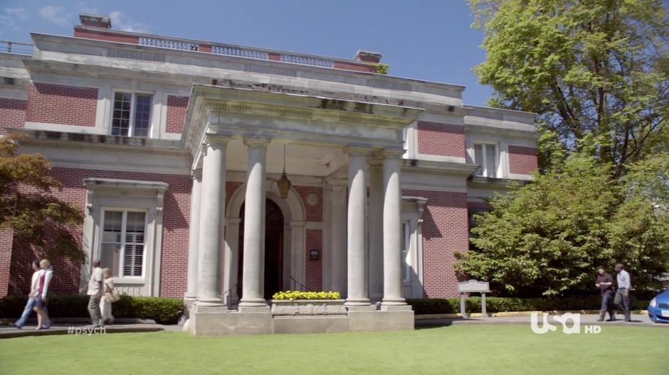 Shawn and Gus approach the front entrance of the mansion.