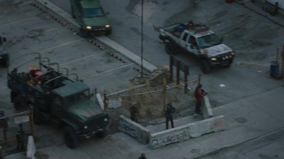 Trucks pull out of the lot after Kathleen sends them to hunt down Henry and the "mercenaries".