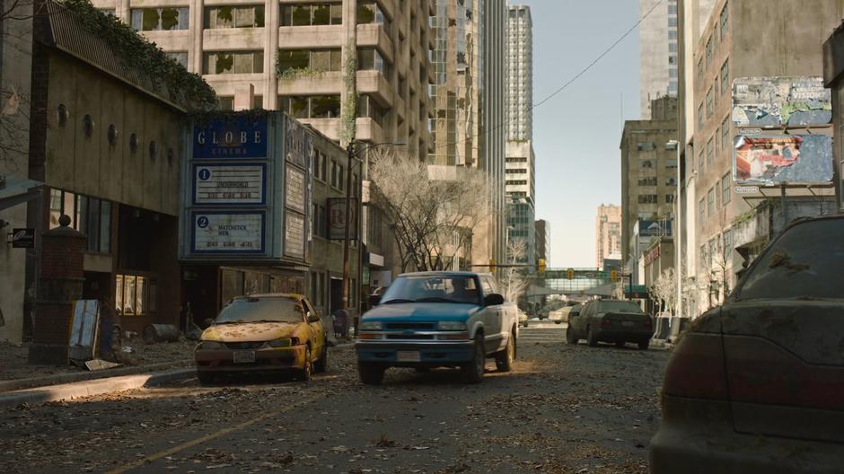 Joel drives the car past an old cinema in downtown Kansas City.