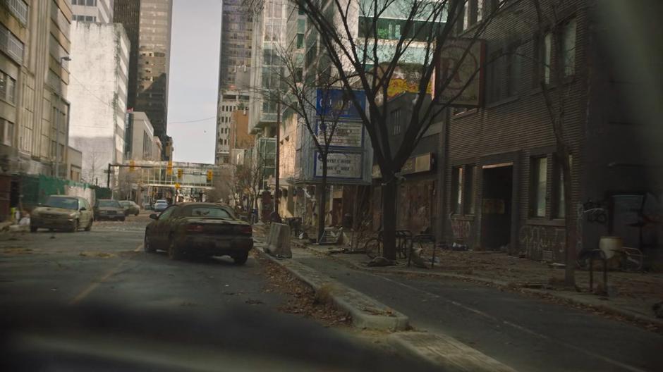 The truck navigates through stopped cars on the street.