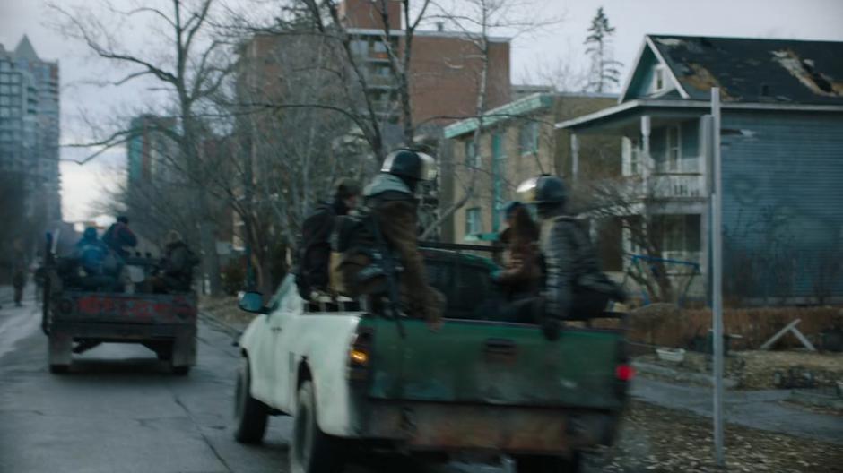 Trucks of goons pile into a neighborhood to search for Henry or the "mercenaries".