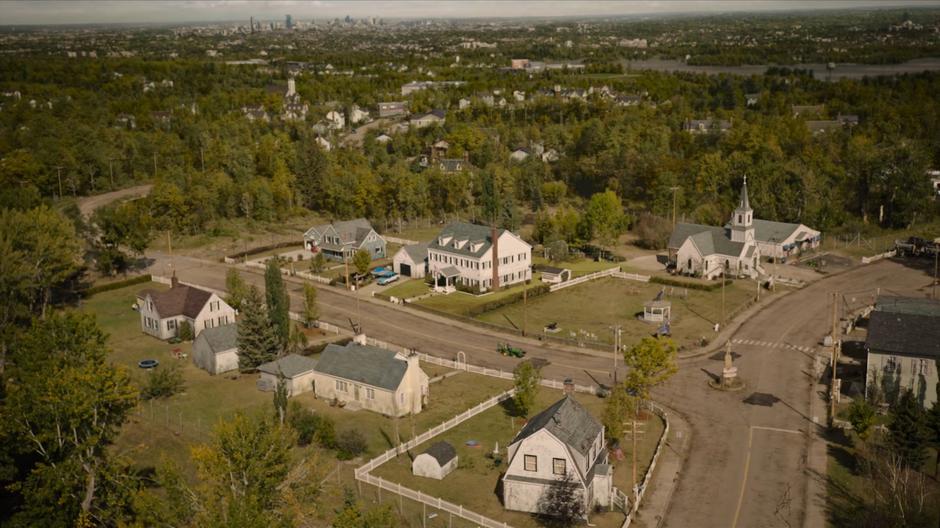 Aerial view of Bill's neighborhood as he drives a tractor down the street.