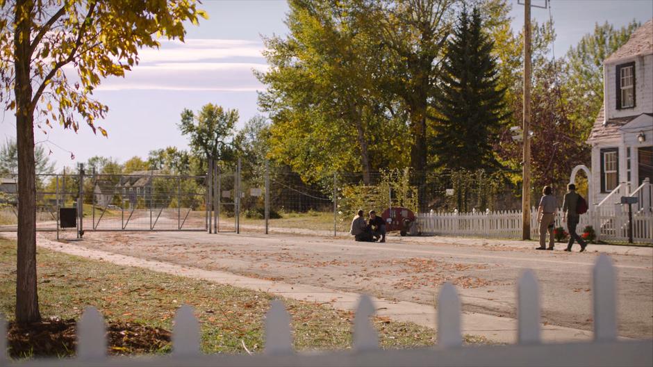 Frank discusses radio codes with Tess while Joel walks over towards Bill.