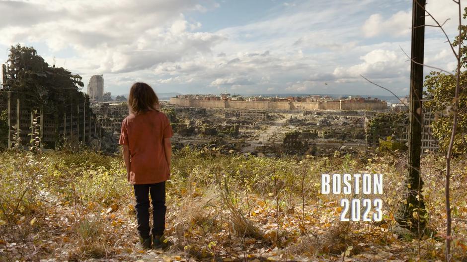 A child stands at the edge of the hill overlooking the Boston QZ.