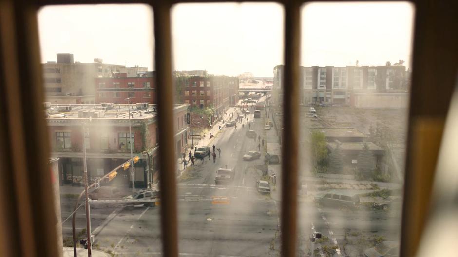 The revolutionaries are visible searching the street outside the attic window.