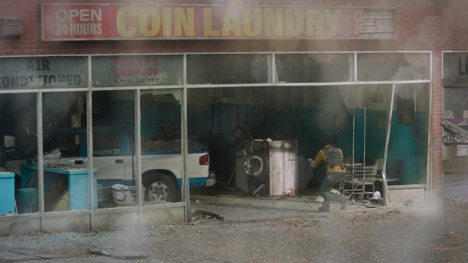 One of the amushers is visible entering the laundromat from Henry's view across the alley.