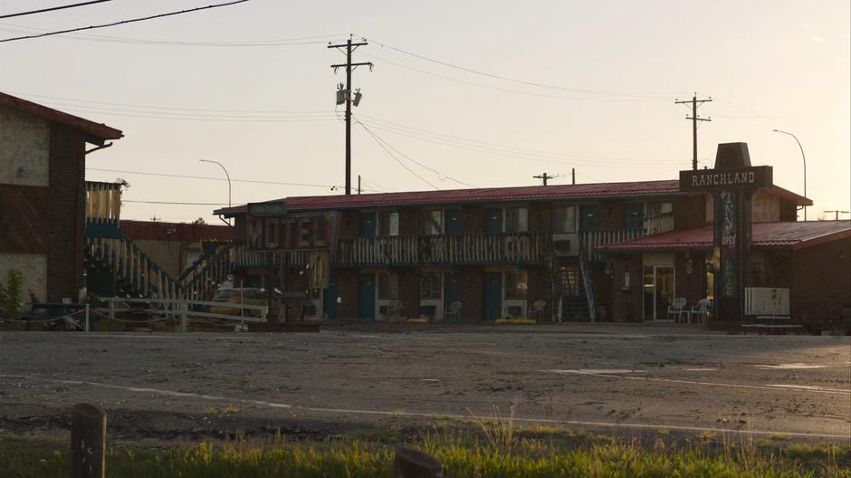 The sun rises over the exterior of the motel.