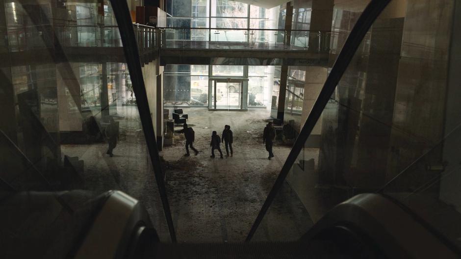 Henry leads Sam, Ellie, and Joel out of the lobby to the tunnel entrance.