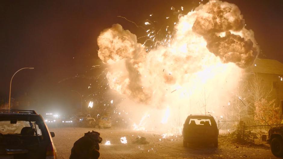 A massive explosion lights the street from the crashed truck.