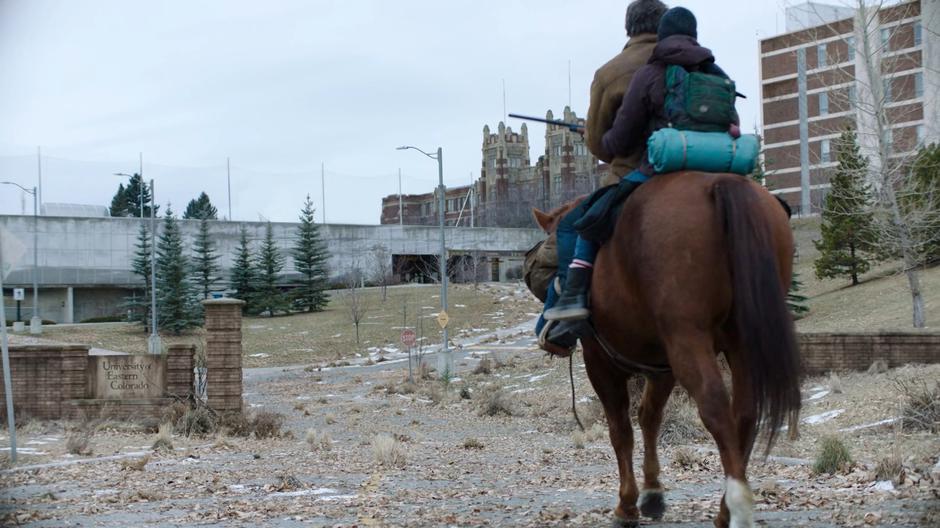 Joel and Ellie ride up to the University of Eastern Colorado gate.