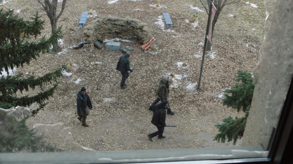 A group of four raiders are visible walking past out the lab window.