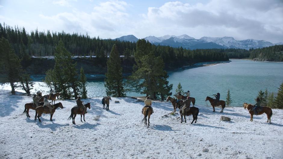 Ellie and Joel put their hands up when they are surrounded by riders.