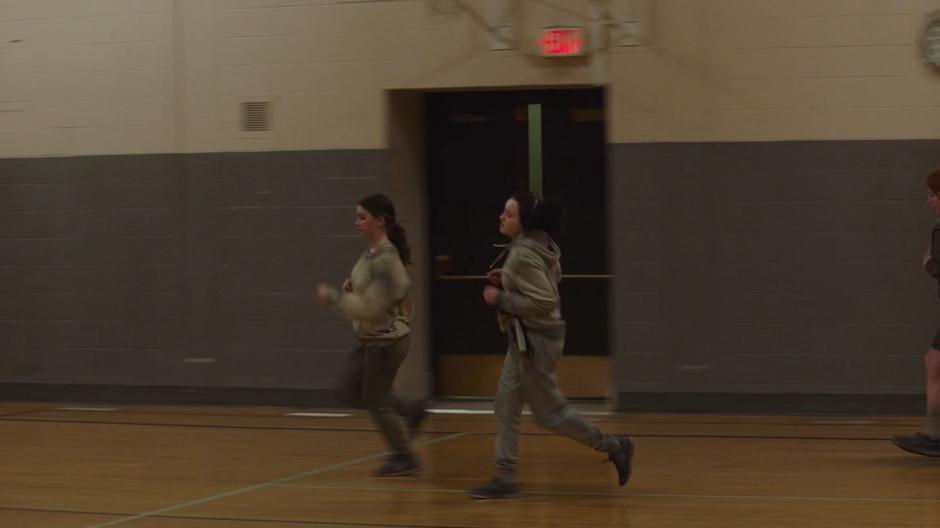 Ellie jogs around the gym listening to her Walkman.