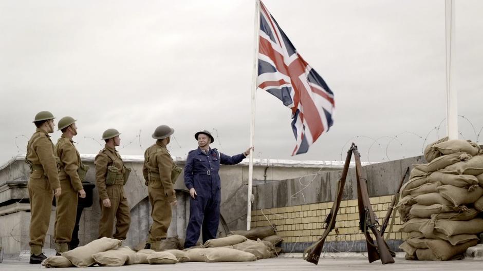 Soldier's raise the flag on the roof of the war rooms.