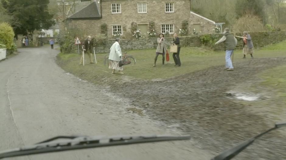 Come Upper Leadworth citizens are being attacked as the Doctor approaches in his van.