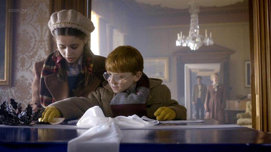 Lily and Cyril examine the giant Christmas present.