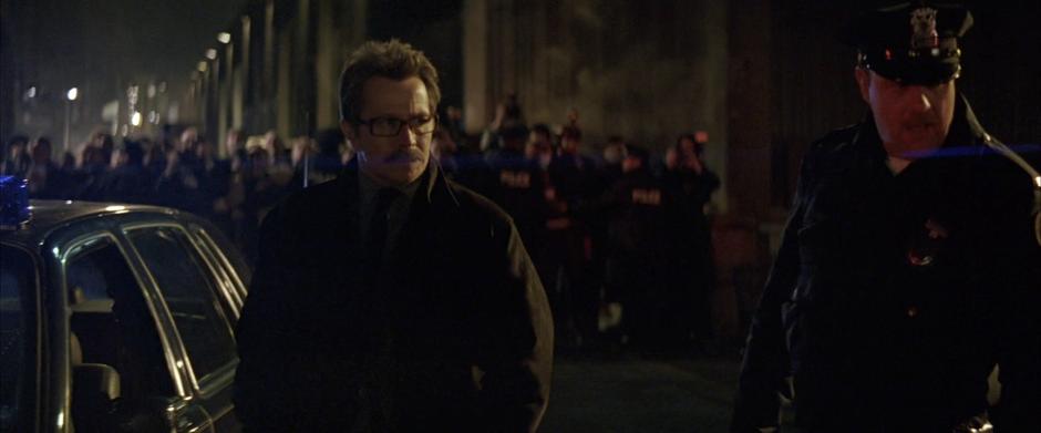 Jim Gordon enters the crime scene on the docks.