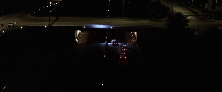 The Batmobile turns off its lights and hides from police pursuit.