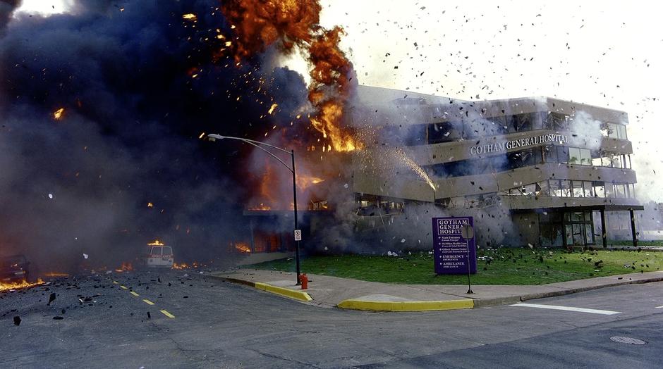 The hospital explodes and collapses after the school bus drives away.