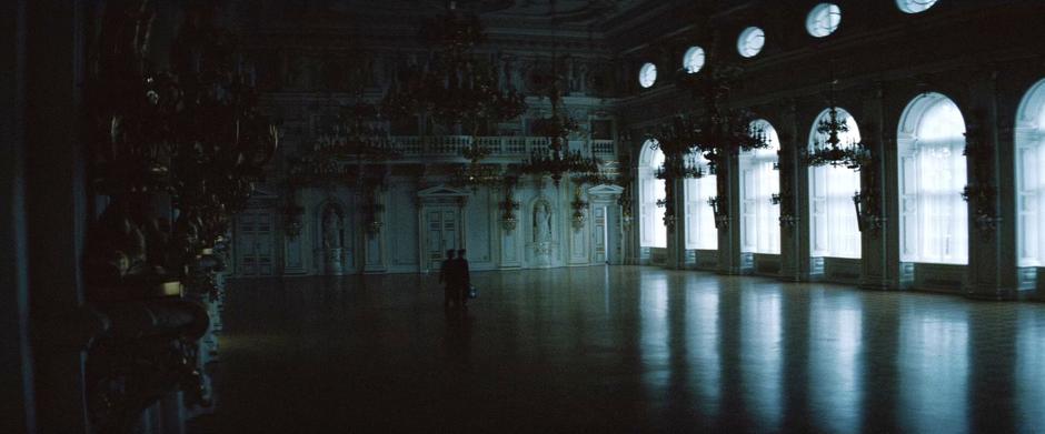 Ethan Hunt and Benji Dunn walk through a hall in the Kremlin.