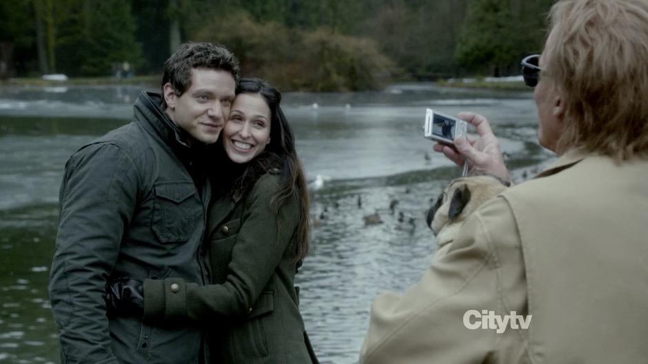 Anson Carr takes the photos of a potential couple by the lake.