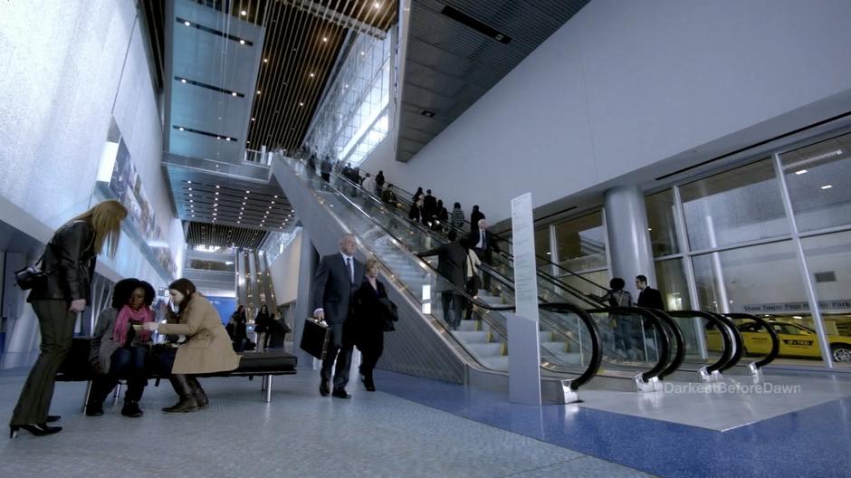 Folks ride the infected escalator.