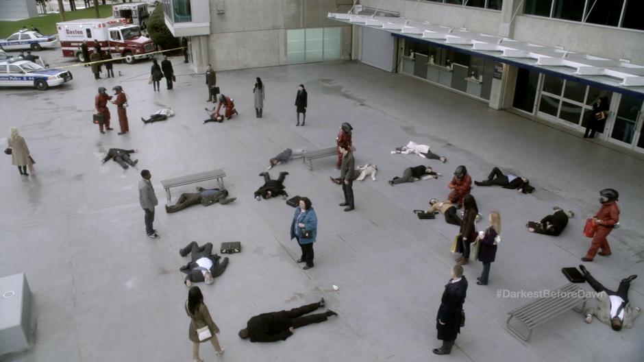 Infected people stand around while FBI agents in hazmat suits investigate their condition.