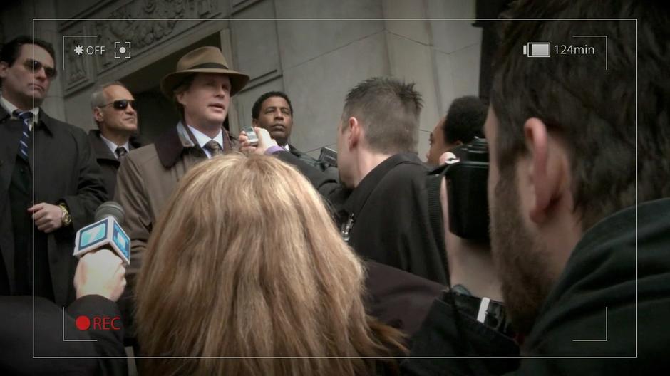 Scott Roemer talks to the press on the steps of the courthouse.