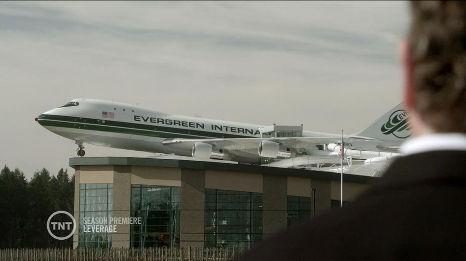 Nate looks at the airplane on top of the aviation museum.